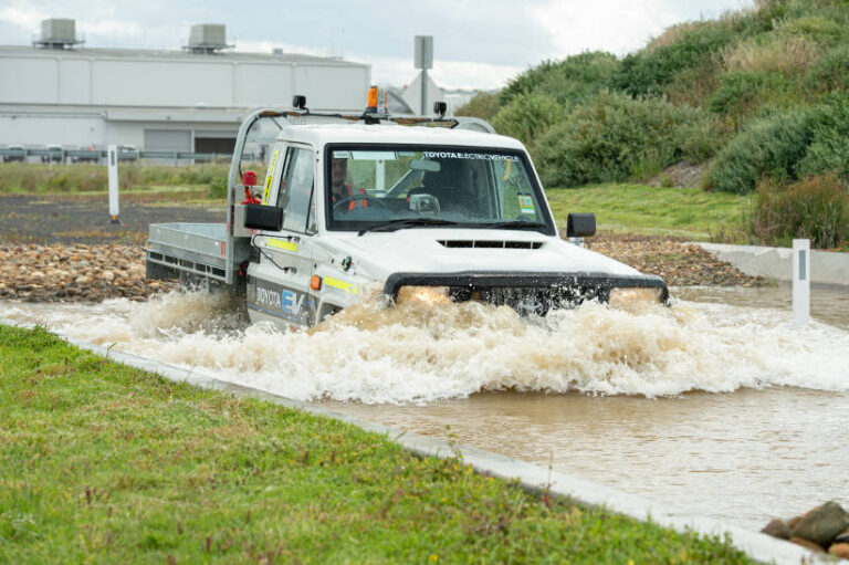 Electric Landcruiser Toyota drives through water