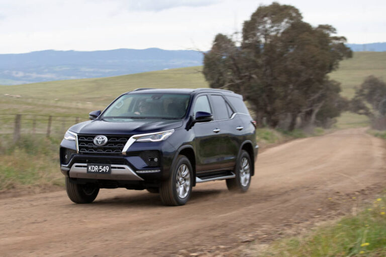 Toyota Fortuner driving on a dirt road