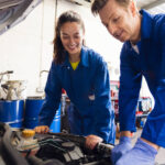 Man and women working on a car