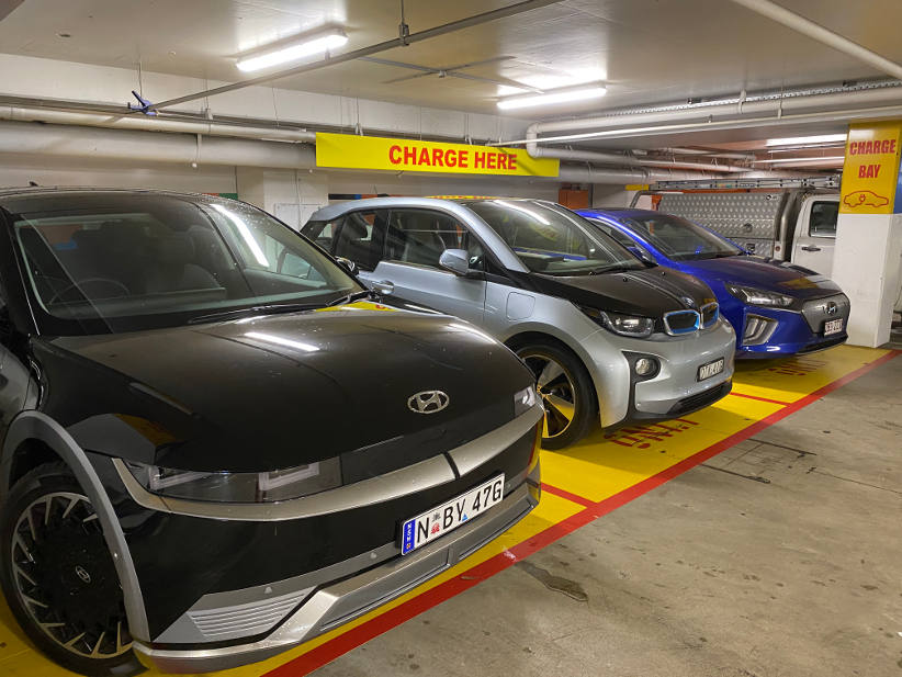 a row of vehicles charging electricity