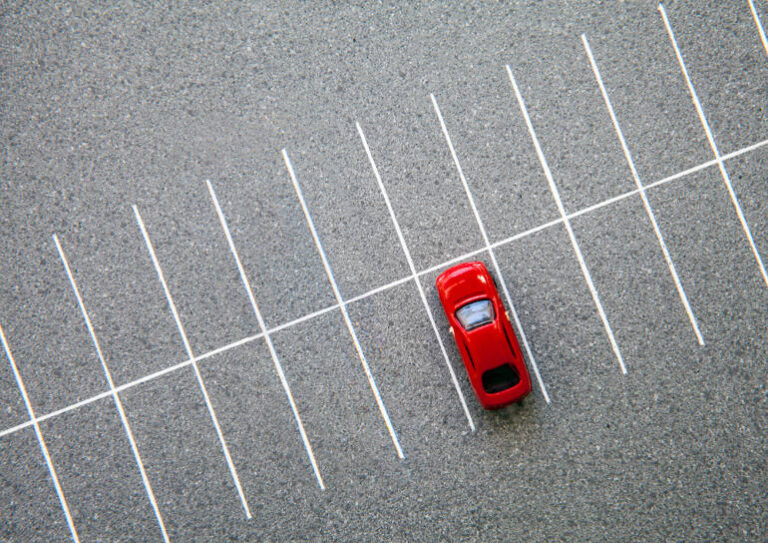 single red car in carpark