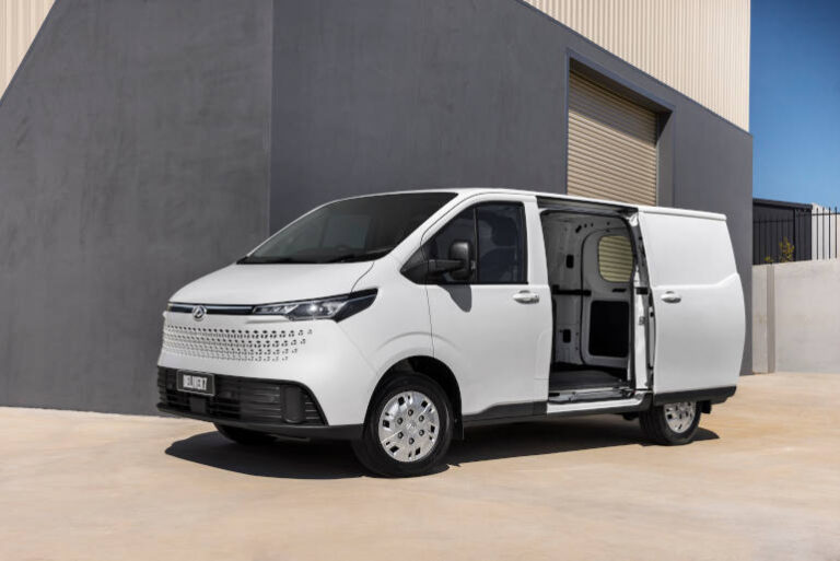 white delivery van parked outside warehouse